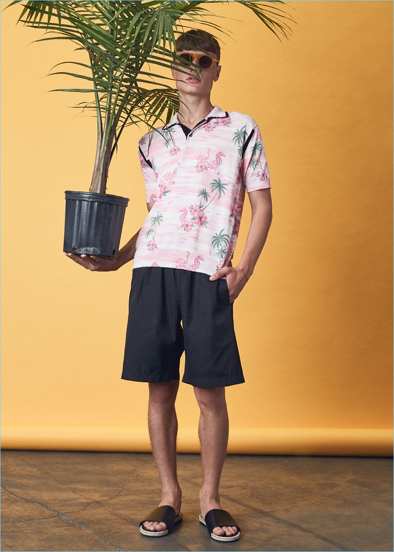 Playing it cool, Vanya rocks a Junya Watanabe Aloha pattern print polo $1,073, Comme des Garçons Shirt cotton poplin shorts $432, Haider Ackermann leather sandals $715, and Dries Van Noten sunglasses $345.