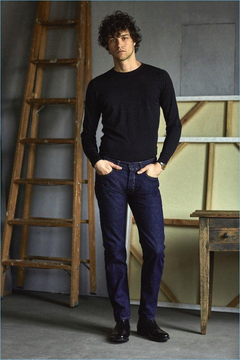 Miles McMillan dons a John Smedley sweater $285 with Todd Snyder selvedge denim jeans $198.