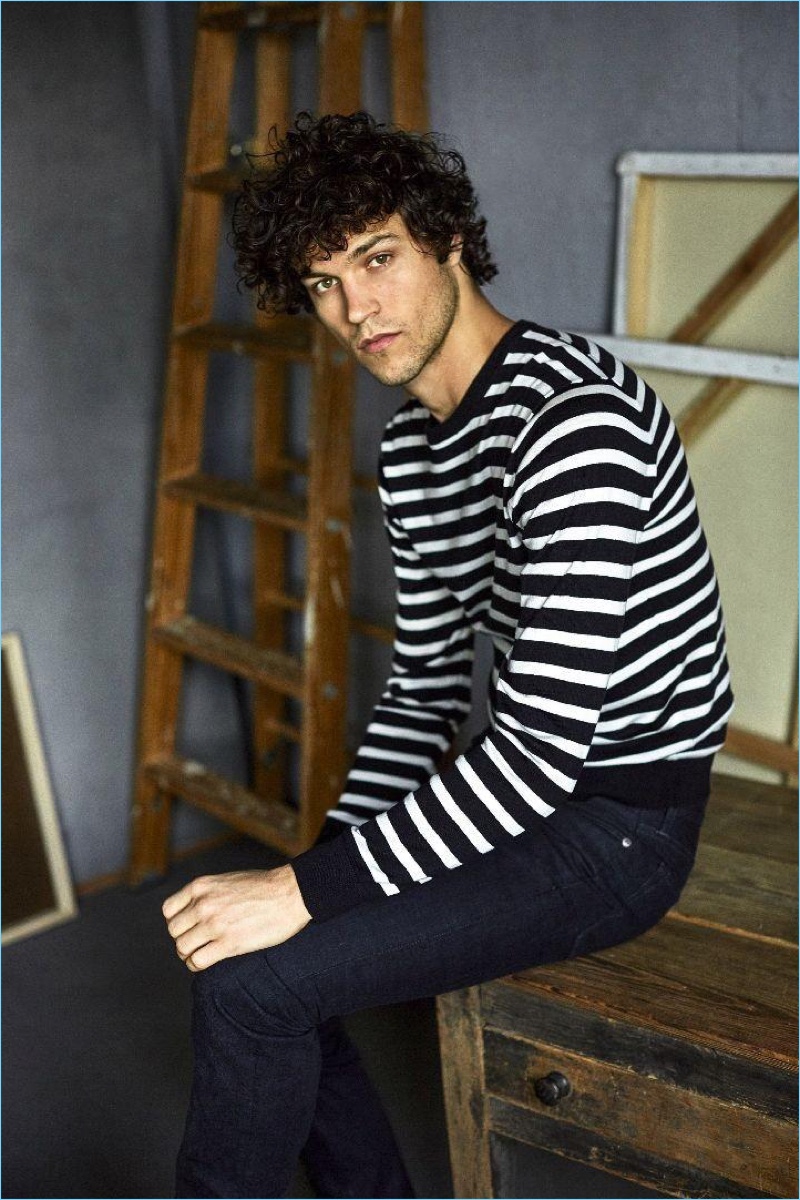 Model Miles McMillan goes casual in Todd Snyder selvedge denim jeans $198 with a striped sweater $168.