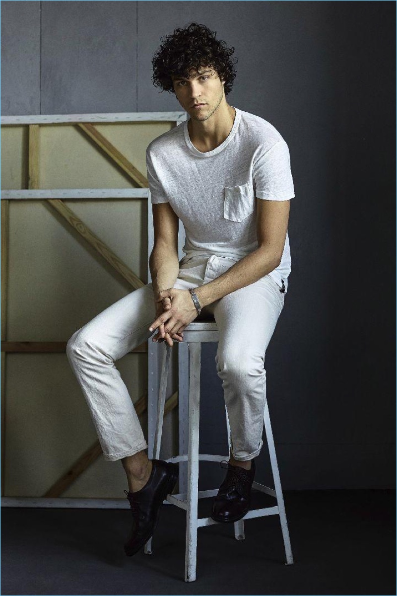 A relaxed image, Miles McMillan wears a Todd Snyder classic button pocket tee $78 with selvedge denim jeans $198.