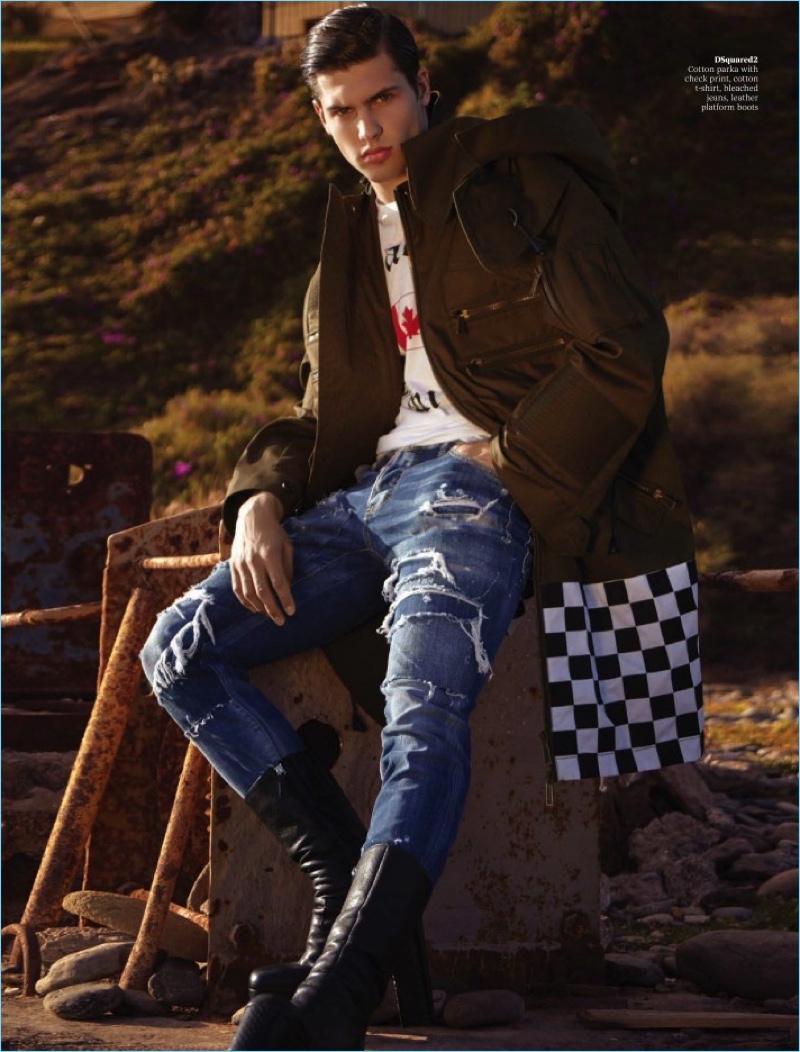Going casual, Miroslav Cech wears distressed denim jeans, a graphic tee, and parka with boots by Dsquared2.