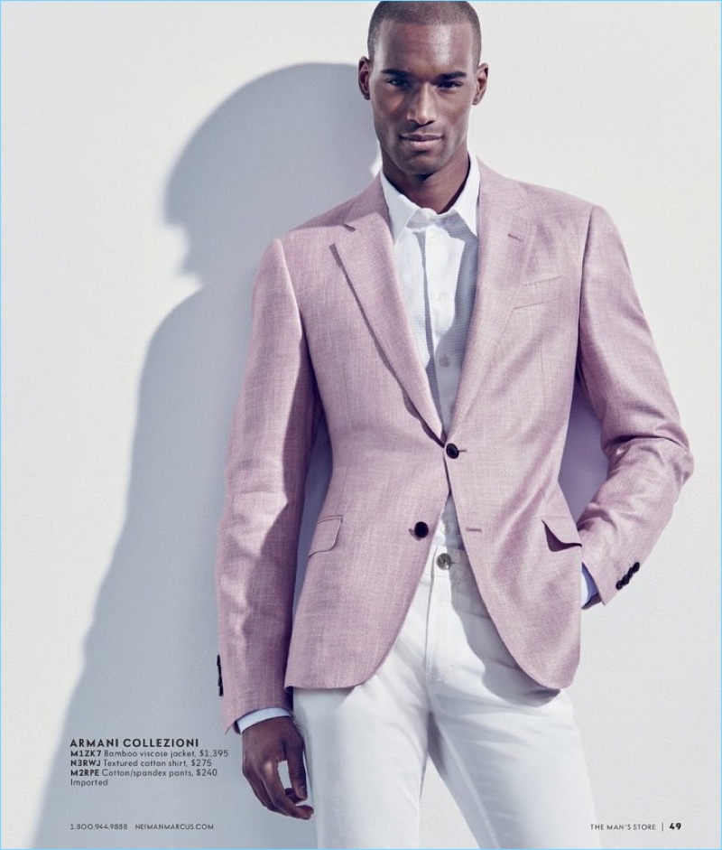 Corey Baptiste dons a pink and white look from Armani Collezioni.