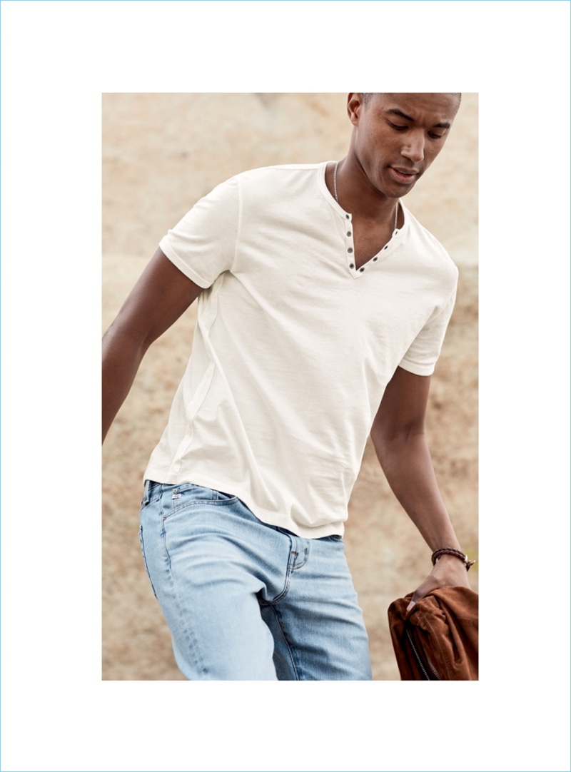 Claudio Monteiro wears a John Varvatos Star USA henley $88 and AG Jeans Matchbox slim-fit jeans $235.
