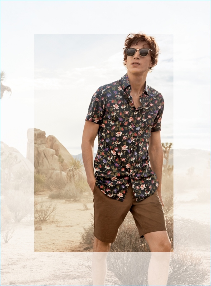 French model Xavier Buestel wears Ray-Ban Classic Clubmaster 51mm sunglasses $150, a Rodd & Gunn floral print shirt $148, and Bonobos stretch washed chino 9-inch shorts $78.