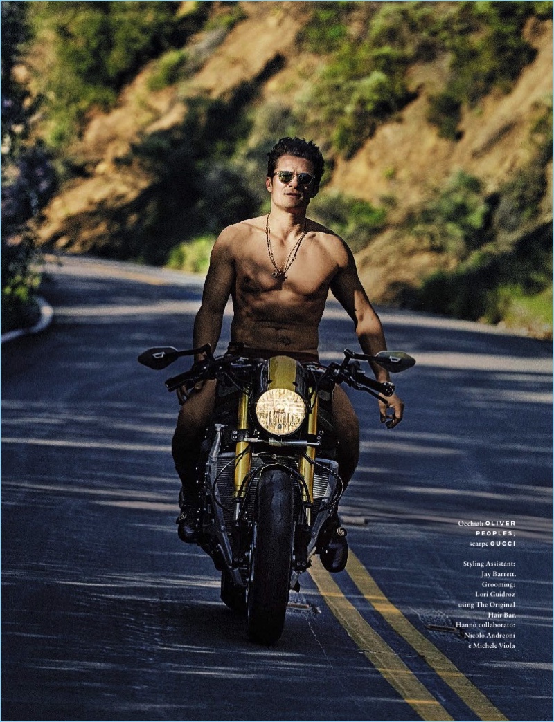 Going shirtless, Orlando Bloom rocks Oliver Peoples sunglasses, American Apparel underwear, and Gucci boots.