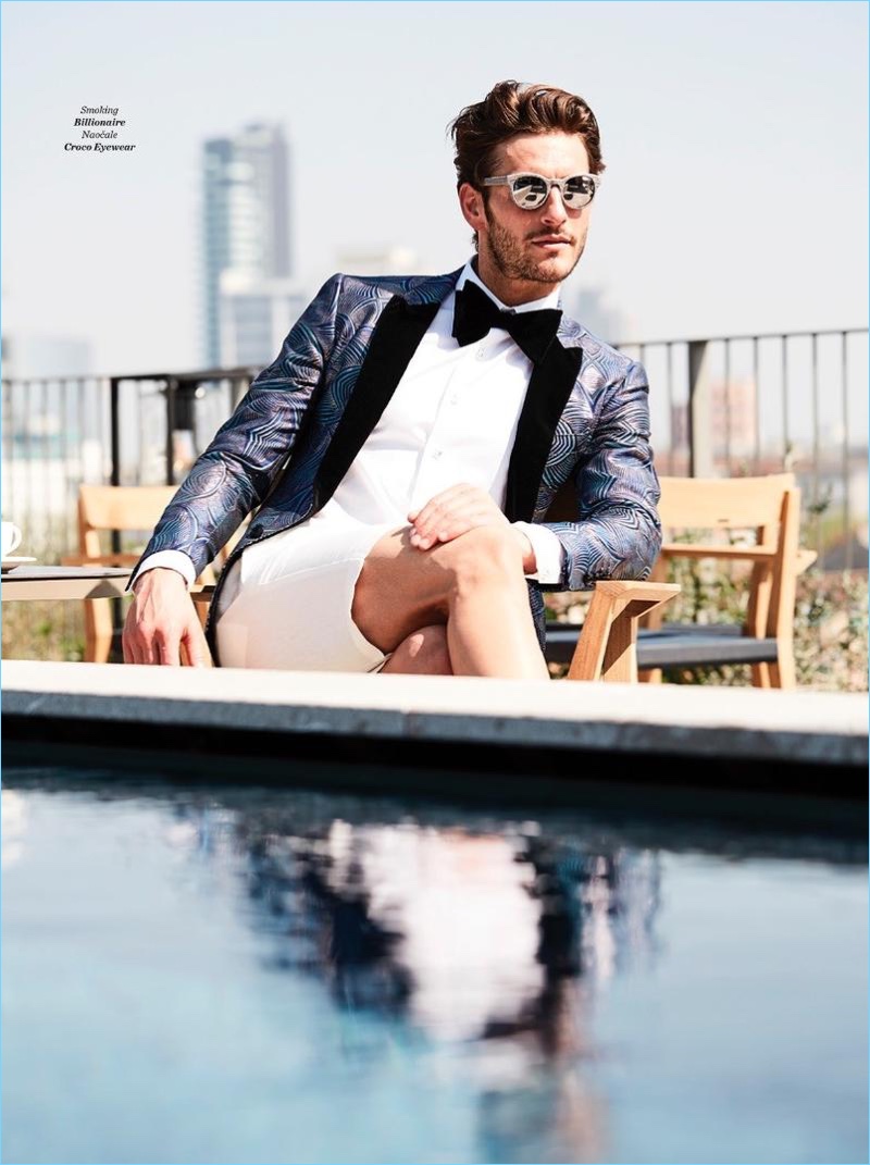 Embracing a dapper look, Parker Gregory wears a smoking jacket by Billionaire with Croco sunglasses.