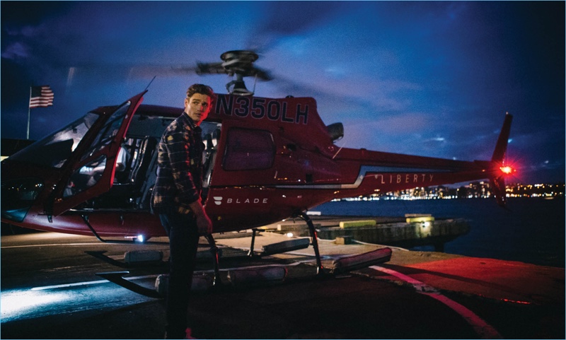 Ready to take flight in a helicopter, Patrick O'Donnell wears a look from Louis Vuitton.