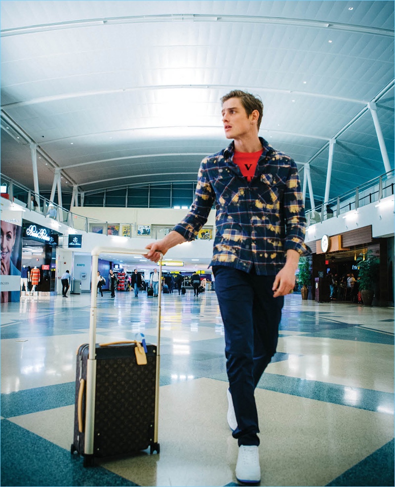 Patrick O'Donnell takes to the airport in Louis Vuitton with the brand's signature luggage in toll.