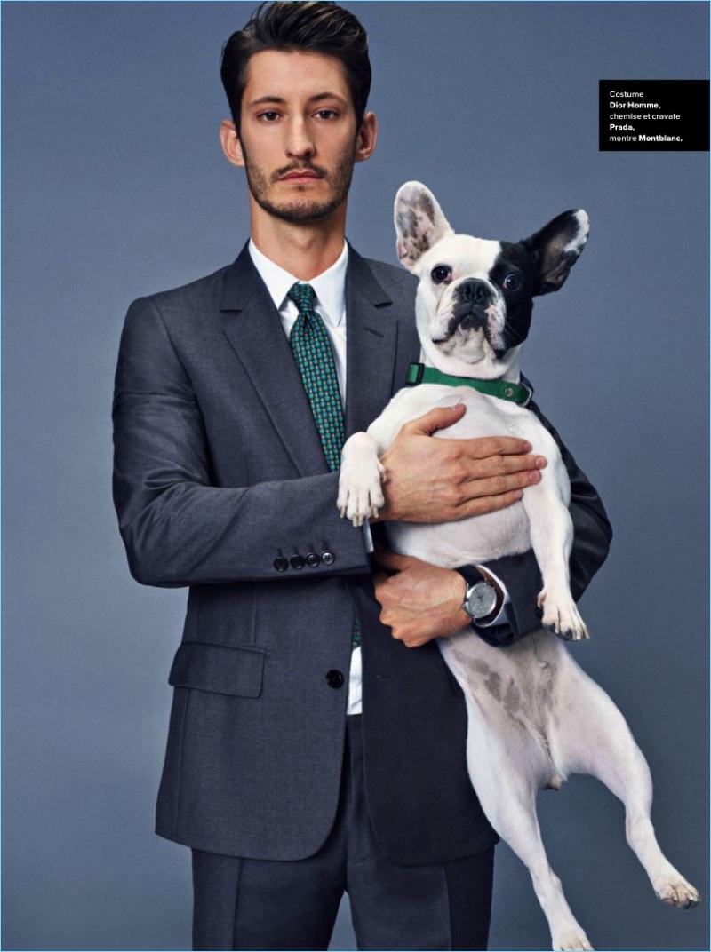 Actor Pierre Niney suits up in Dior Homme. He wears a Prada shirt and tie with a Montblanc watch.