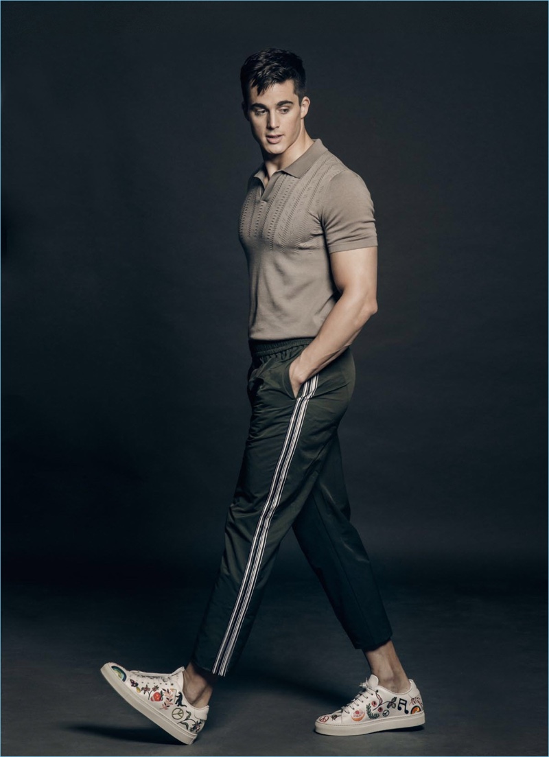 Strutting his stuff, Pietro Boselli dons a BENCH polo with Wood Wood pants and Paul Smith sneakers.