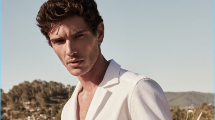 French model Julien Sabaud wears a Reiss white Cuban-collar shirt $145 with slim-fit chinos $180.