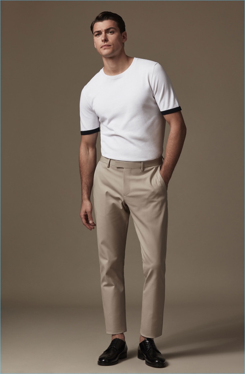 Keeping it simple, FIlip Wolfe models a short-sleeve knit shirt $145 with slim-fit chinos $180 and patent leather shoes $340.