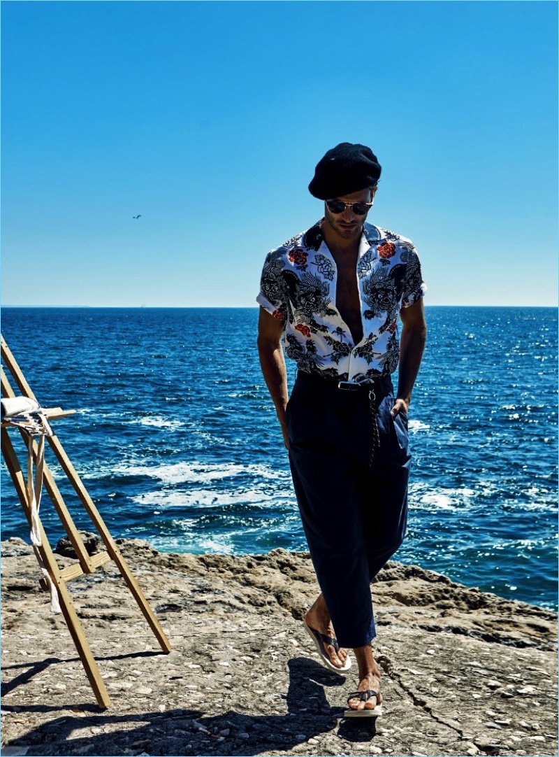 Taking to the coast, Ricardo Oliveira wears a Gucci shirt with COS trousers, Carrera sunglasses, and Havaianas flip-flops.
