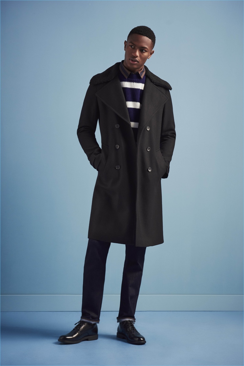 Hamid Onifade wears a double-breasted coat with a striped sweater and skinny jeans from River Island's fall-winter 2017 collection.