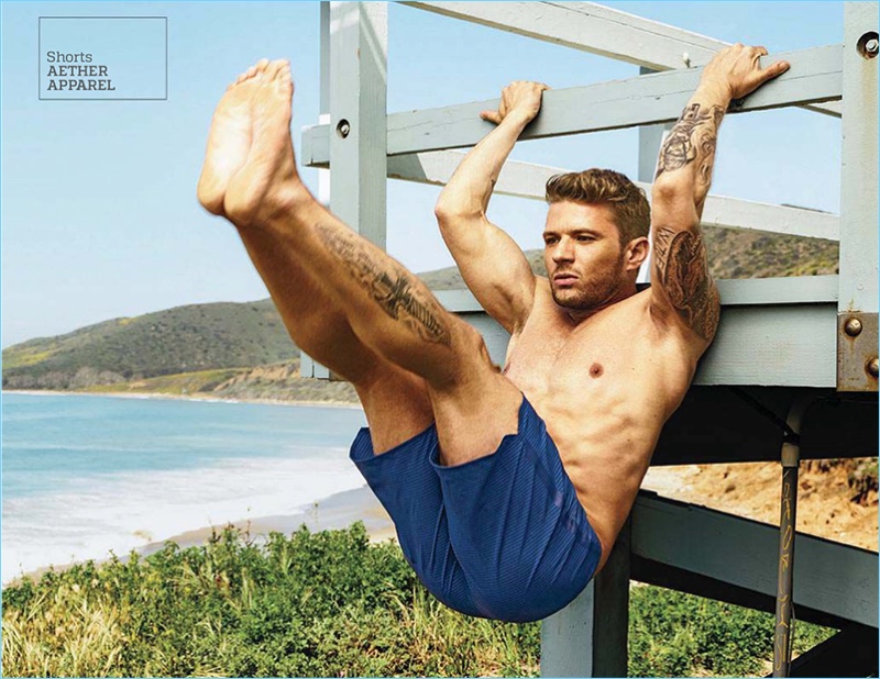 Performing a hanging leg raise, Ryan Phillippe wears Aether Apparel shorts.
