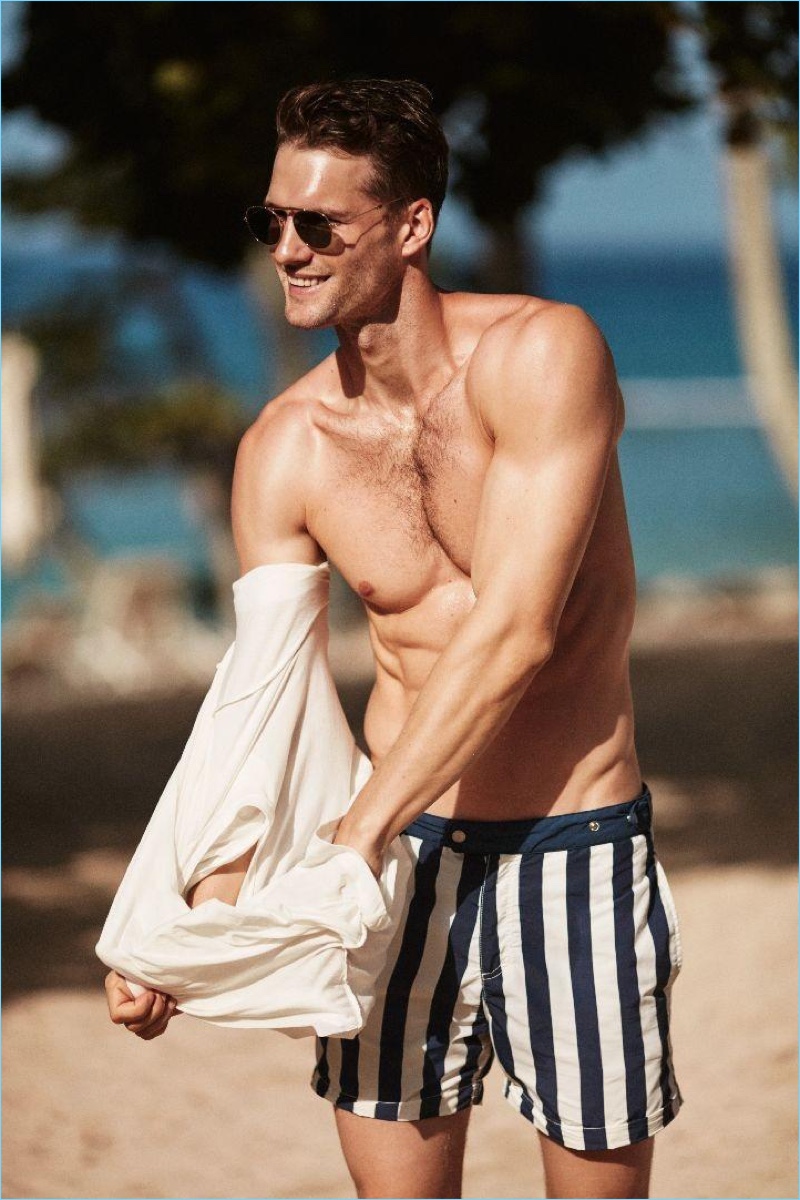 Tomas Skoloudik wears striped swim shorts from Solid & Striped.