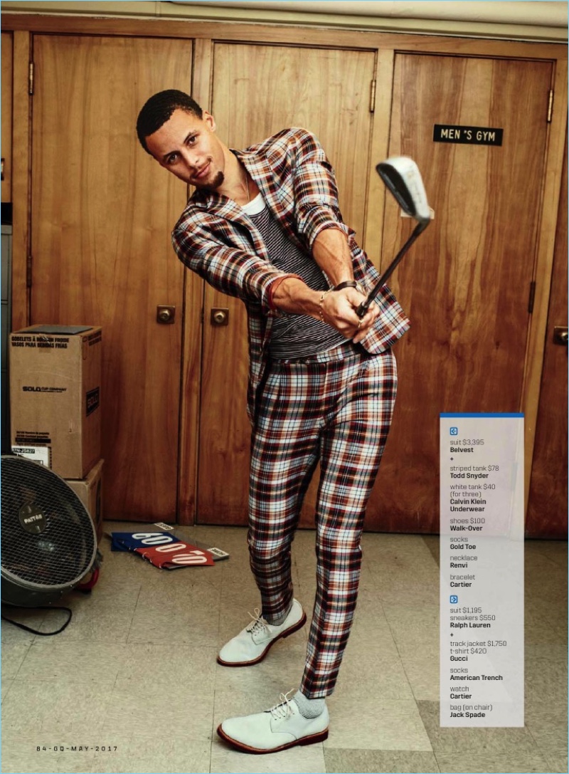 Working on his golf game, Steph Curry dons a Belvest check suit with a striped Todd Snyder tank, Calvin Klein tank, and Walk-Over shoes.