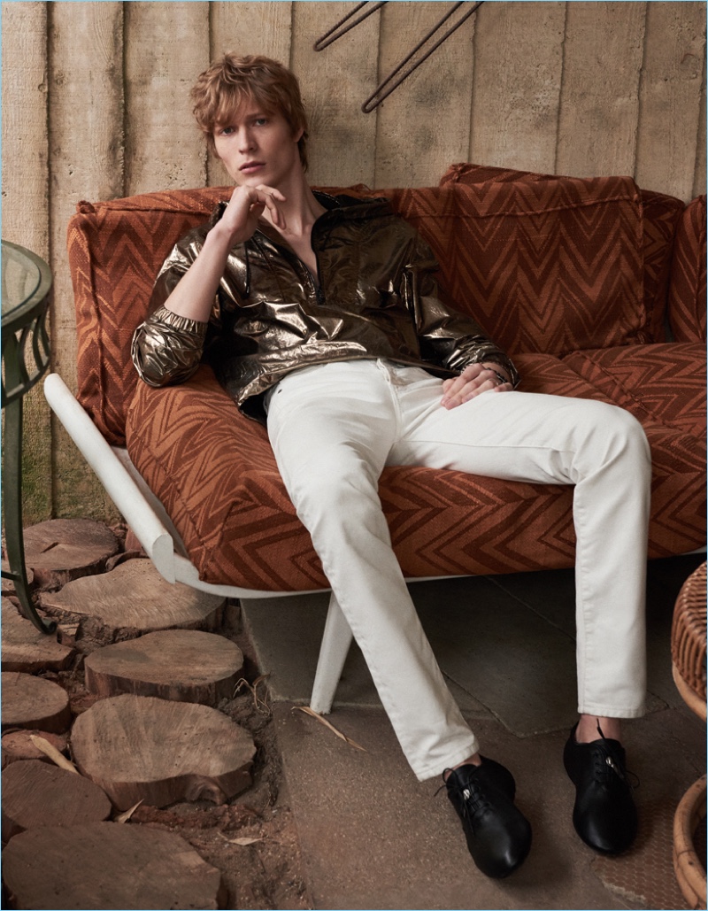 Embracing a bold gold jacket from Saint Laurent, Sven de Vries also wears skinny jeans from the label. Sven's look is complete with the brand's black shoes.