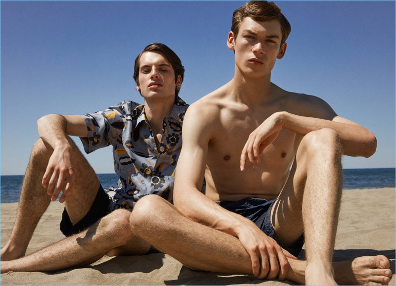 Models Andrea Silenzi and James Mcvay take to the beach with Luisaviaroma for a style edit. The models sport swimwear from Vilebrequin and MC2 Saint Barth. Andrea also wears a Fendi short-sleeve shirt.