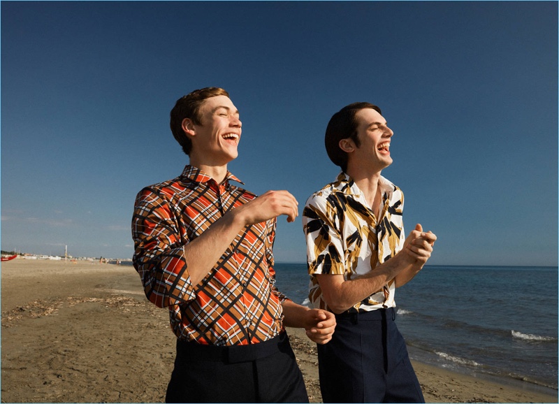 Left to Right: All smiles, Jamie Mcvay wears a Maison Margiela check shirt $515 and Dsquared2 chinos $620. Andrea Silenzi models a Marni flower print shirt $580 and oversized twill pants $680.