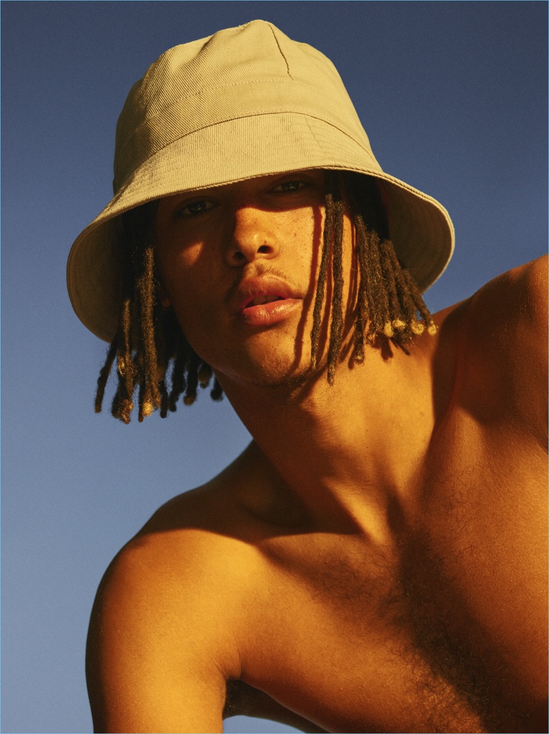 Channeling nineties style, James Magee rocks a bucket hat from Weekday.