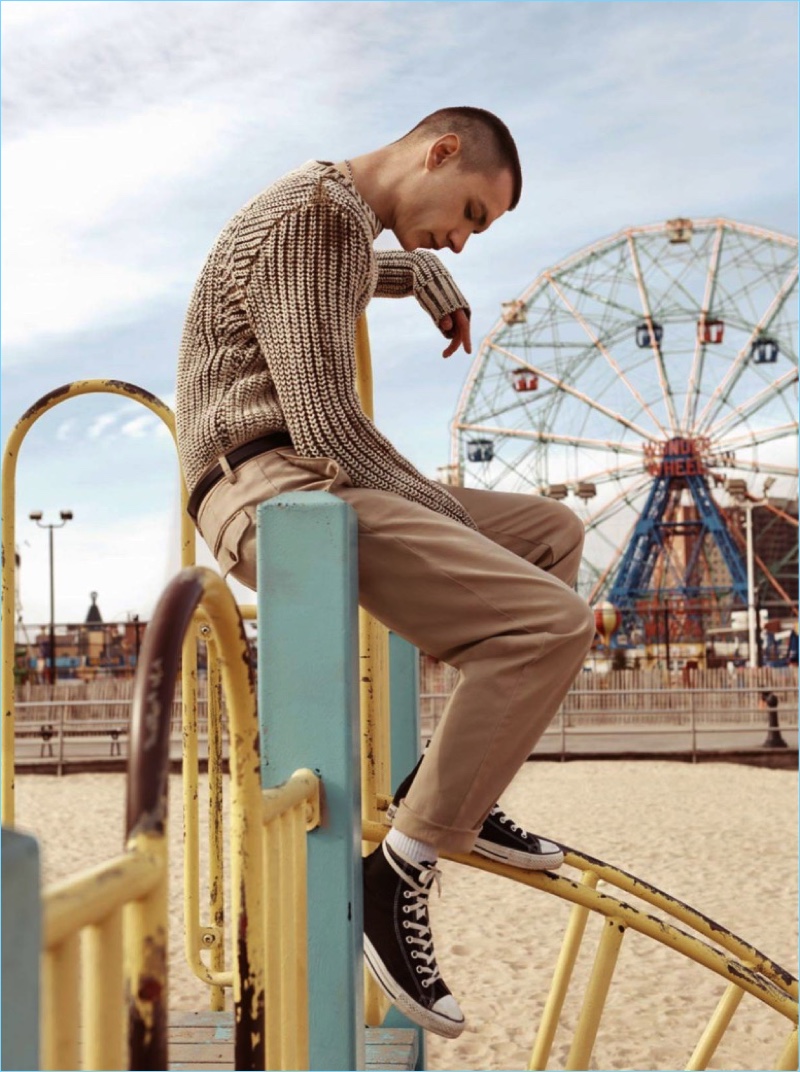 Embracing neutrals, Yuri Pleskun sports a Stone Island sweater with American Vintage pants and Converse sneakers.