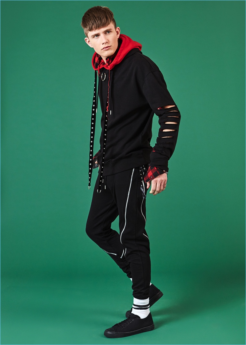 Tapping into a rebellious punk edge, Tom May rocks red and black fashions from boohooMAN.