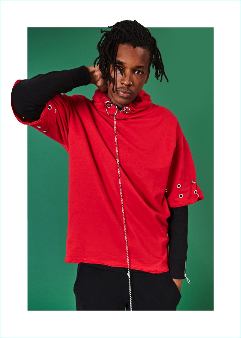 Front and center, Matthew Davidson wears a short-sleeve red hoodie with a long-sleeve black top from boohooMAN.