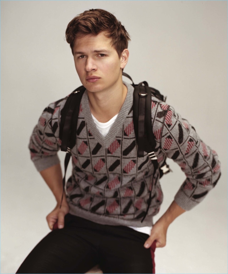 Appearing in a Nylon Guys photo shoot, Ansel Elgort wears a Comfort Colors t-shirt with a sweater and pants by Lanvin.