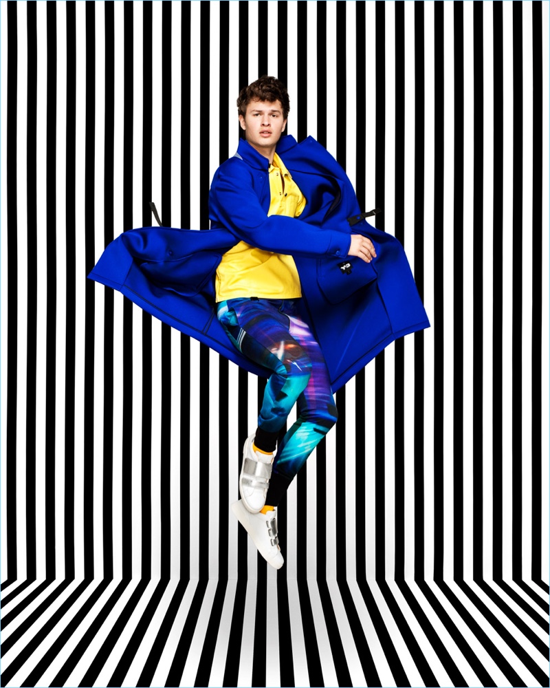 Making a colorful statement, Ansel Elgort rocks a blue Y-3 coat.