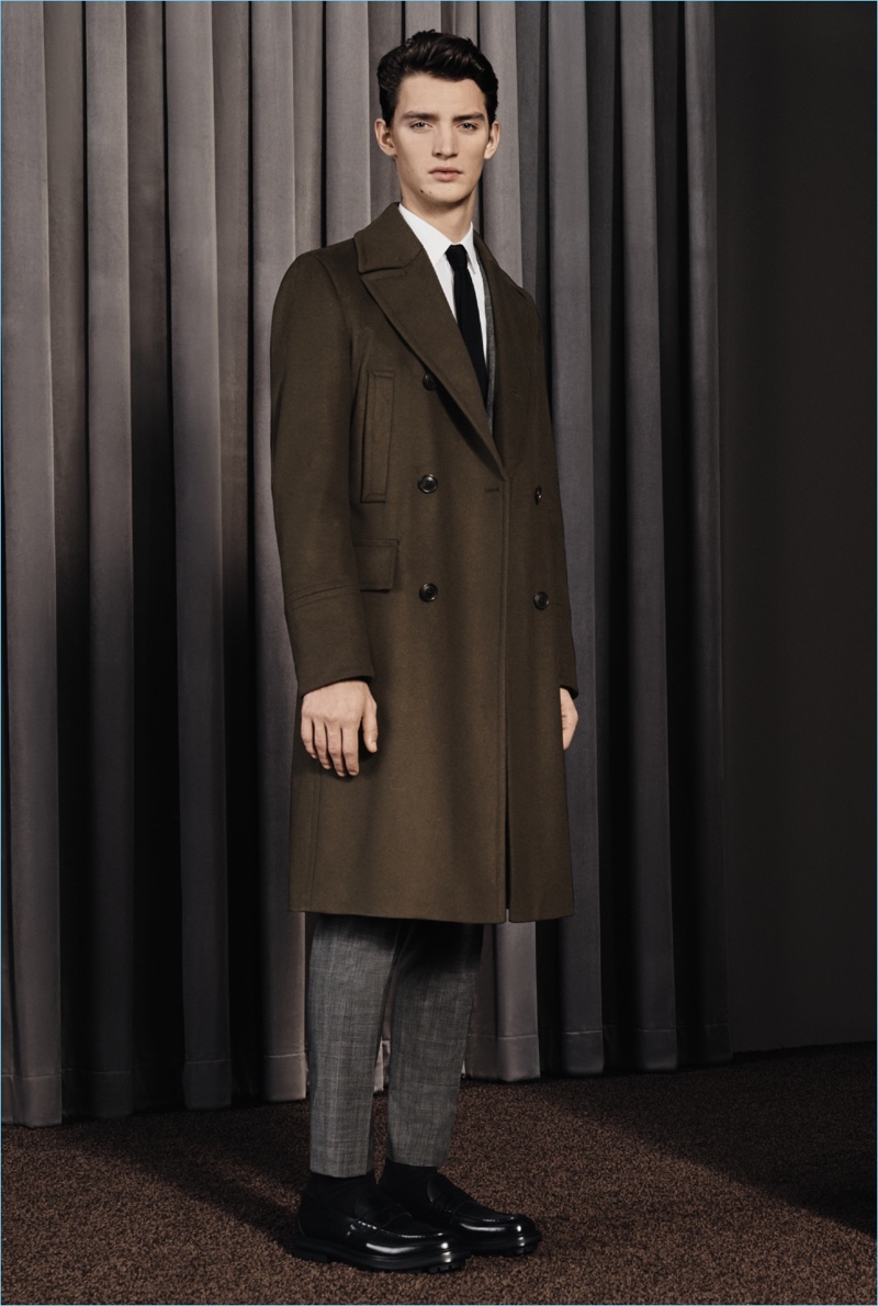 Otto Lotz models a smart coat and suit from BOSS' fall-winter 2017 travel collection.