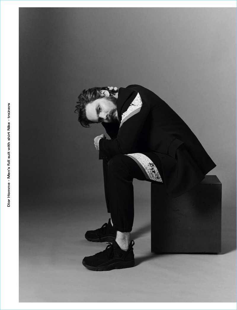 Appearing in a photo shoot for Crash magazine, Daniel Brühl sports a Dior Homme shirt and suit with Nike sneakers.