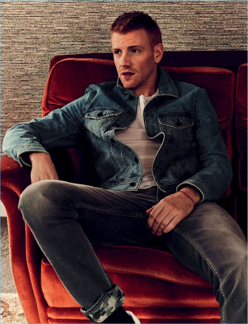 Actor Daniel Newman wears a Diesel t-shirt and denim jacket with 7 For All Mankind jeans.