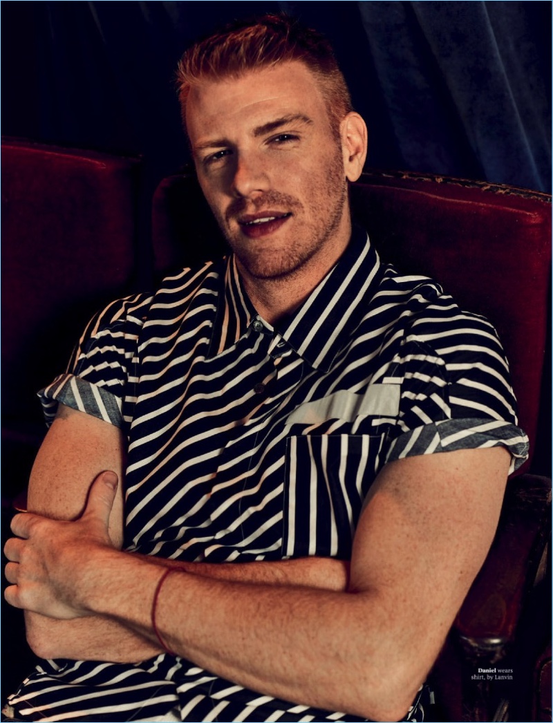 Crossing his arms, Daniel Newman sports a striped shirt by Lanvin.