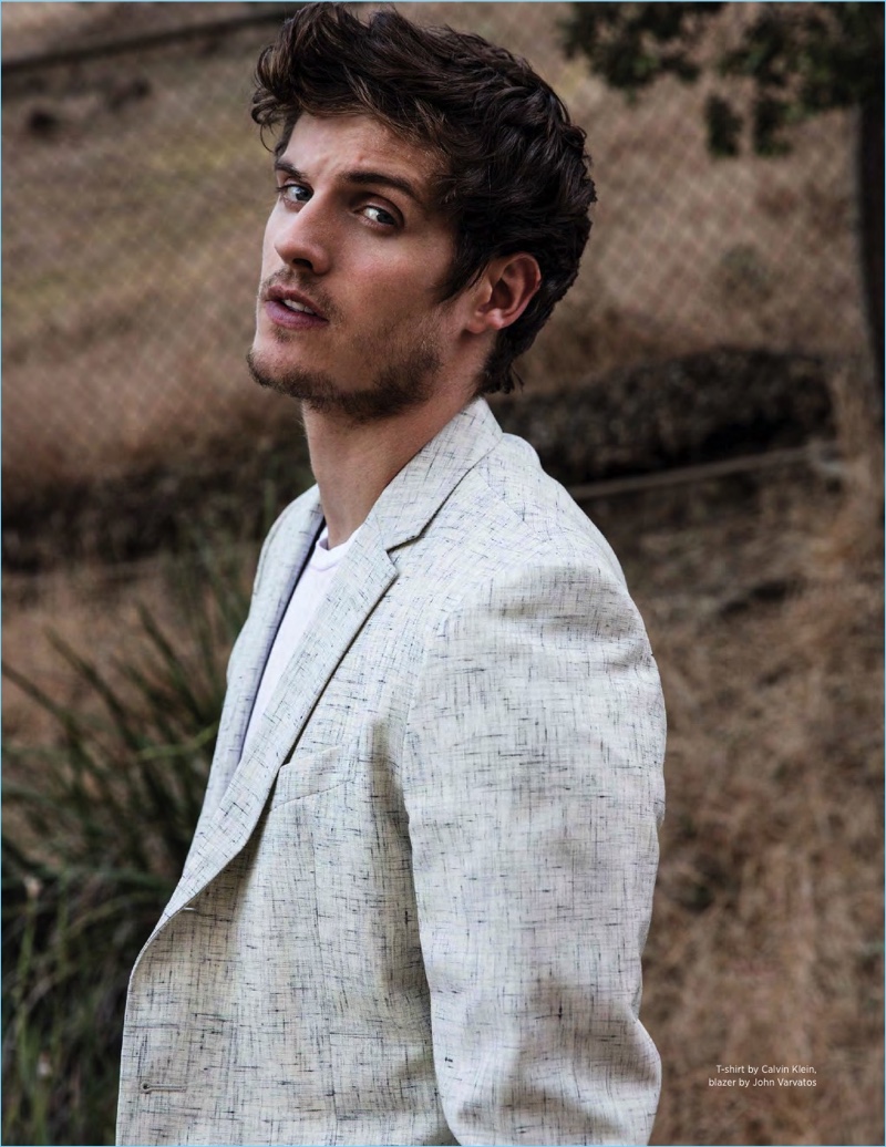 Venturing outdoors, Daniel Sharman sports a Calvin Klein t-shirt with a John Varvatos blazer.