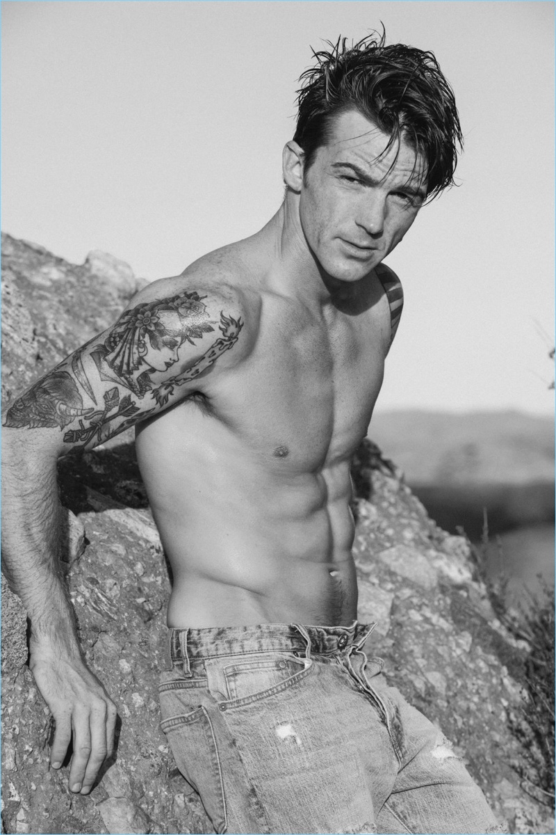 Posing shirtless, Drake Bell wears Frame Denim jeans.