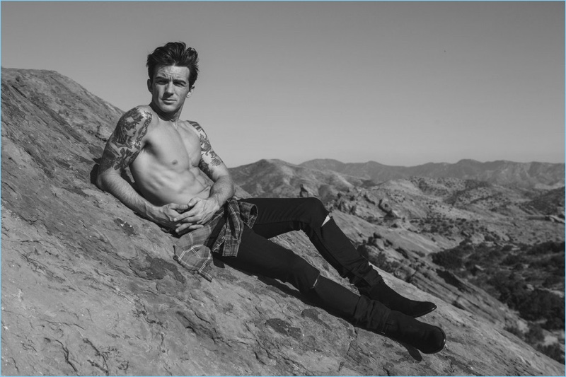 Drake Bell wears a Scotch & Soda shirt with Saint Laurent jeans and boots for Flaunt magazine.