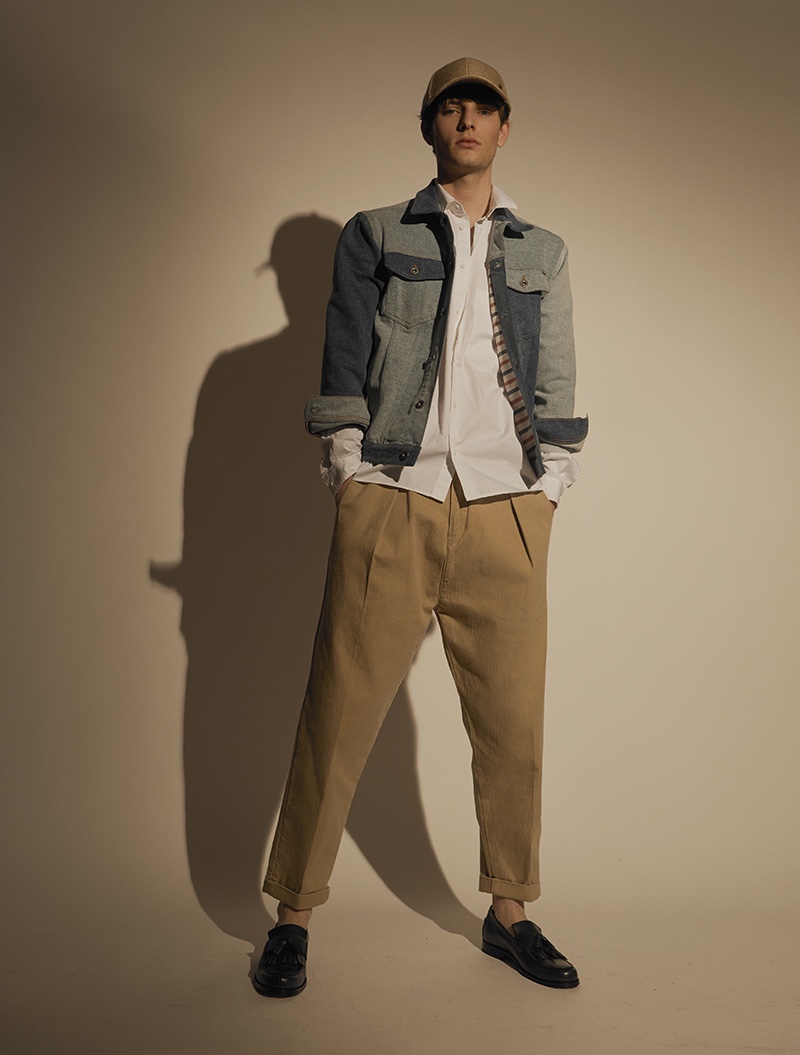 Thomas wears shirt COS, jacket Tommy Hilfiger, trousers Levi's Made & Crafted, cap Esprit, and shoes Tod's.