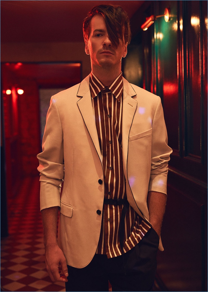 Robert Alfons wears Lemaire trousers $440 with a Lanvin evening jacket $1,852 and oversize short-sleeve shirt $665.