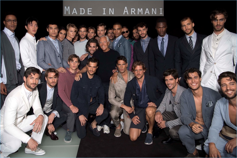 Designer Giorgio Armani poses for photos with the models who participated in his spring-summer 2018 namesake label show.