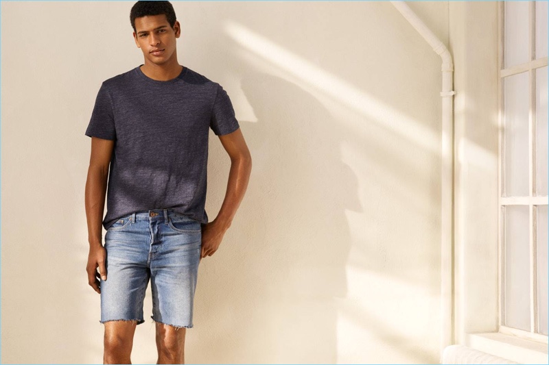 Tidiou M'Baye sports casual denim shorts by H&M.