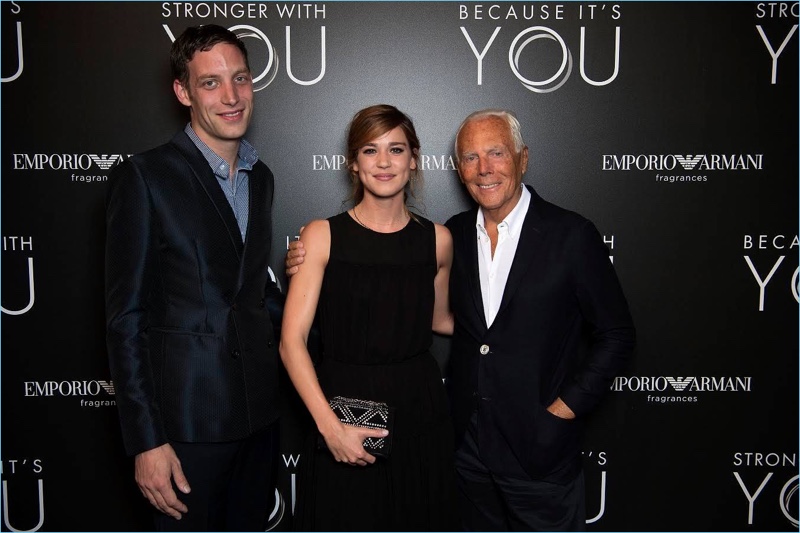 Designer Giorgio Armani poses for photos with James Jagger and Matilda Lutz at Emporio Armani's fragrance launch event.