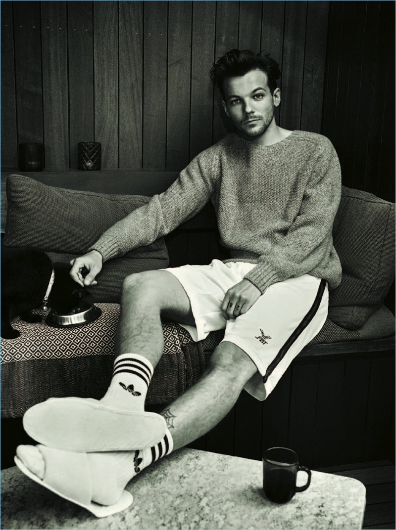 Relaxing, Louis Tomlinson appears in a photo shoot for The Observer magazine.