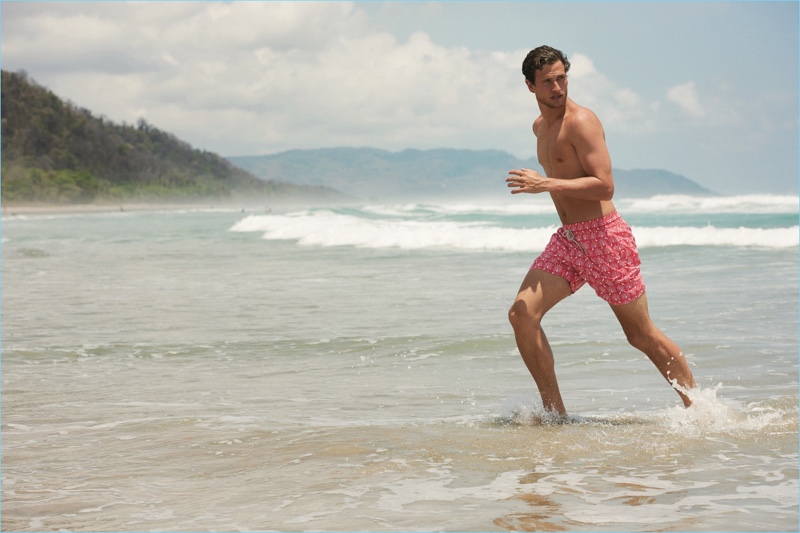 Tom Warren takes to the beach, wearing The Jay & The Peacock swim shorts by Love Brand & Co.