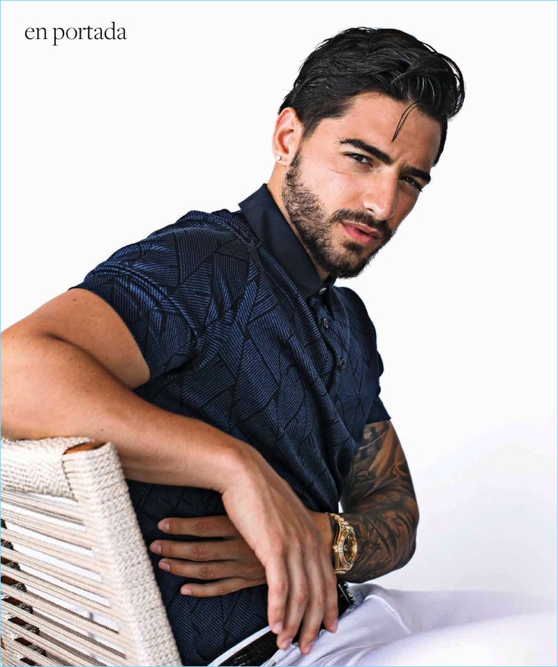 A sleek vision, Maluma sports a polo shirt, white pants, and belt by Hugo Boss.