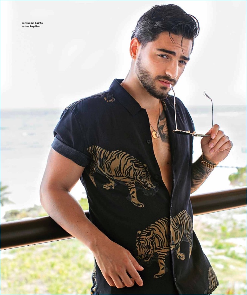 Ready for summer, Maluma wears an AllSaints shirt with Ray-Ban sunglasses.