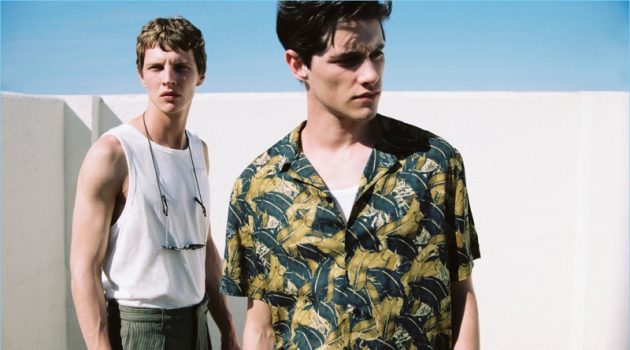 Models Luke Powell and Tim Schuhmacher come together for Mango Man's summer 2017 style edit. Pictured left to right, Tim wears a sleeveless t-shirt $12.99, trousers $69.99, and sunglasses $35.99. Meanwhile, Luke sports a tropical leaf print shirt $59.99 and sleeveless t-shirt $12.99.