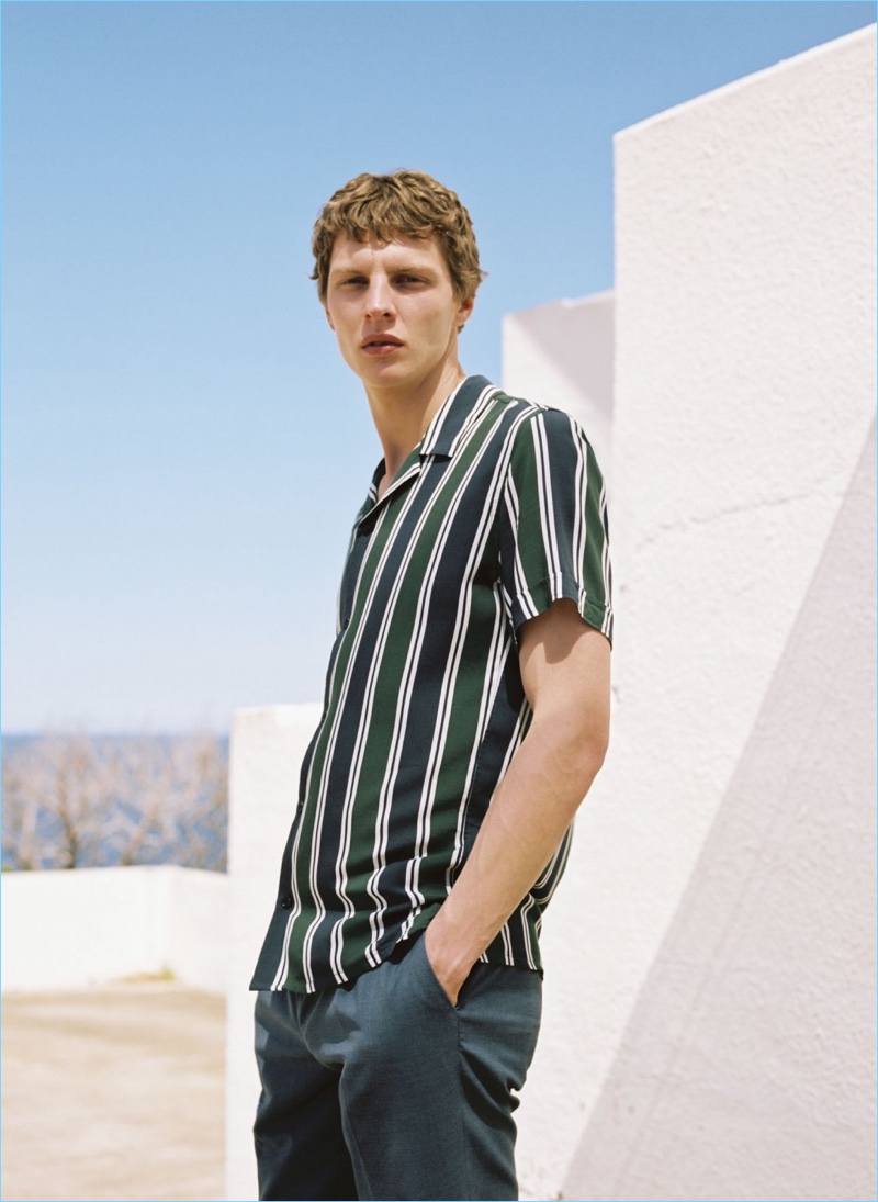 Embracing summer style, Tim Schuhmacher wears a Mango Man striped bowling shirt $59.99 and pleated cropped trousers $59.99.