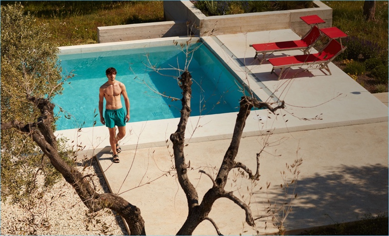 A summer vision, Rodolphe Zanforlini wears Everest Isles swim shorts $181 and Paul Smith leather sandals $192.