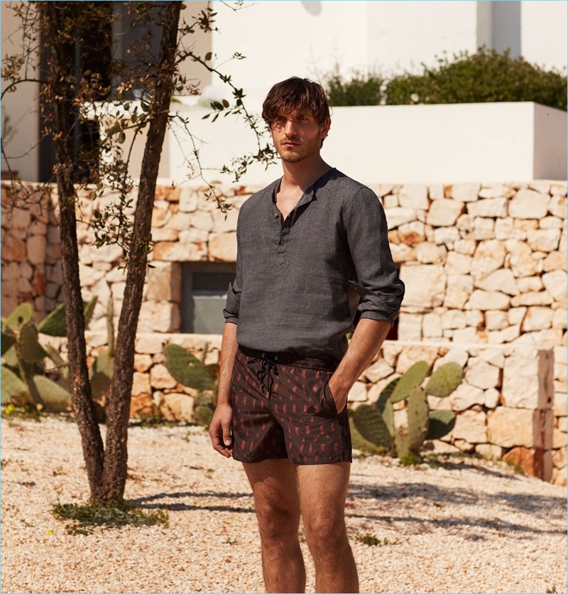 Keeping cool, Rodolphe Zanforlini wears a De Bonne Facture linen shirt $170 and Boglioli smudge-print swim shorts $160.